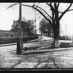 Caption: "Commandant's House south of Evans Street and Little Street in Brooklyn Navy Yard; house is in far left background with two cobblestone streets and large tree in foreground. 1896."